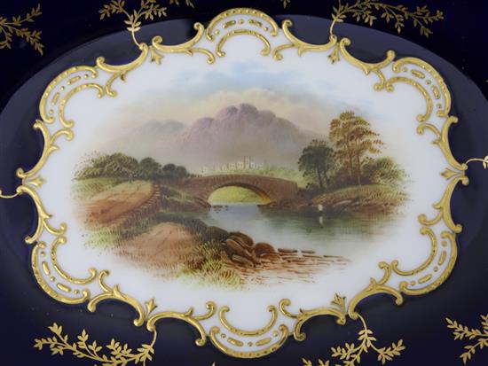 A Coalport named view plate and a pair of matching dessert dishes, c.1900, 26.5cm and 28cm